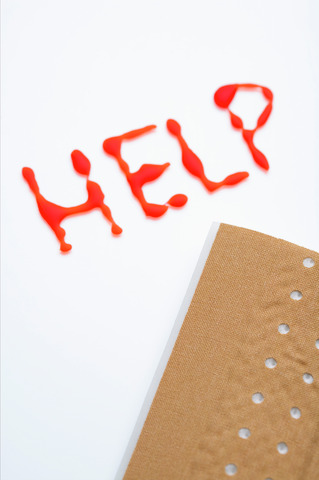 Red written word HELP and a band-aid