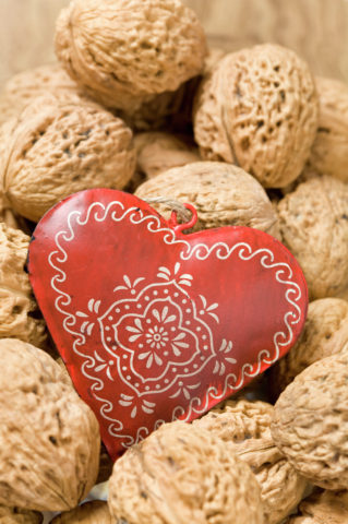Ornate heart among walnuts
