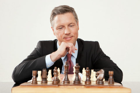 Businessman playing chess