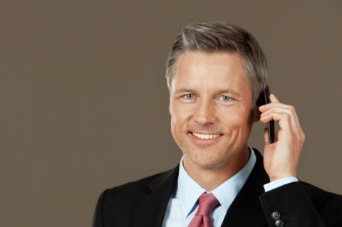 Smiling businessman on the phone