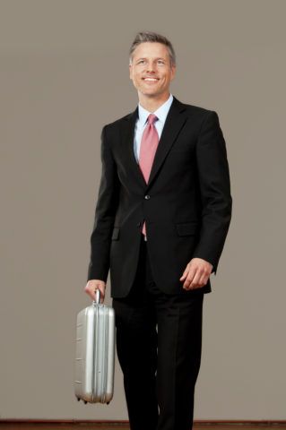 Businessman holding silver suitcase