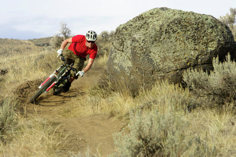 Downhill cyclist driving a turn