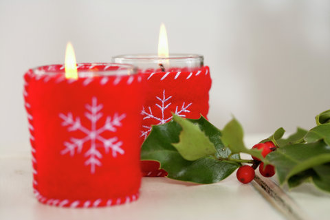 Christmassy candles and holly twig