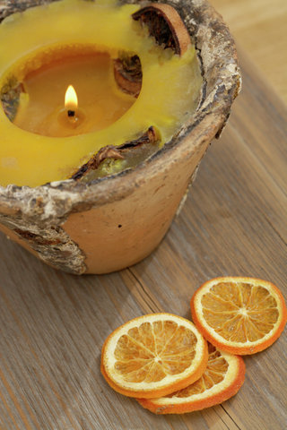 Perfumed candle and orange slices
