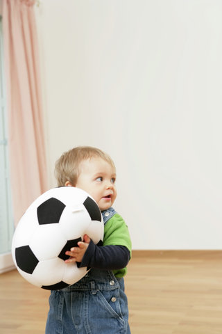 Baby boy holding a football