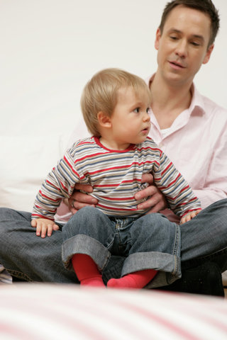 Son sitting on father's lap