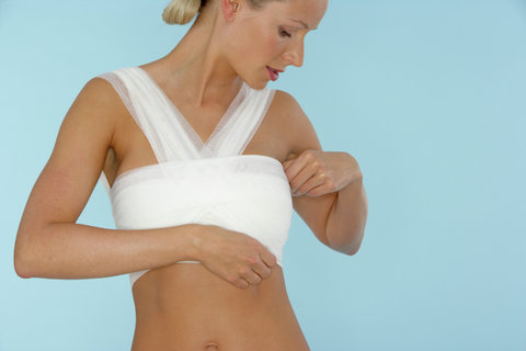 Young woman with bandaged chest, close-up