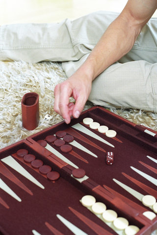 Man playing Backgammon (cropped, detail)