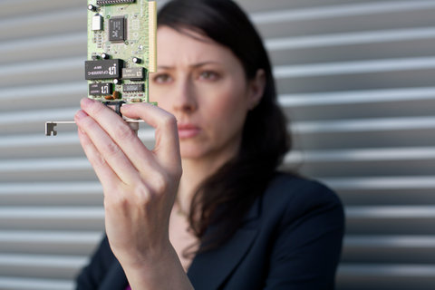 Businesswoman holding a circuit board