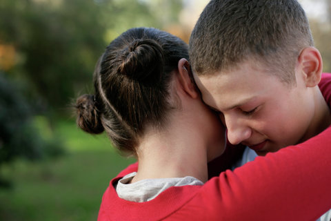 Teenage couple embracing