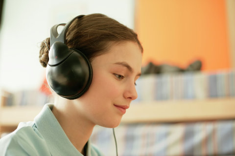Girl listening to music by earphones