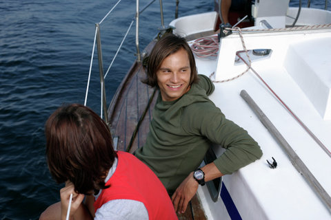 Couple sitting at sailboat border