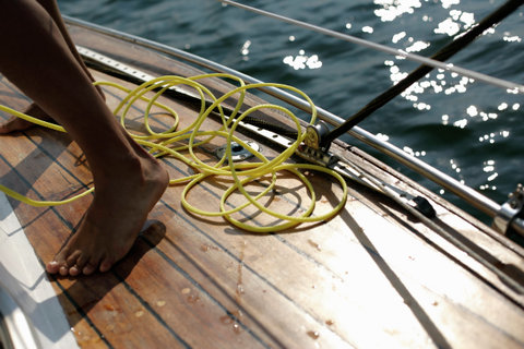 Yellow line between the feet of a man on deck