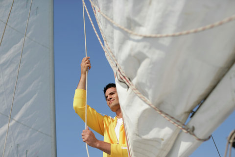Man hoisting a sail