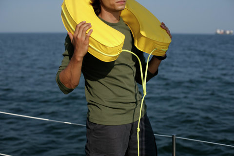 Man having a life ring on his shoulders