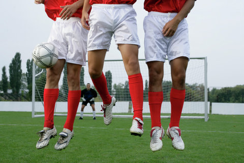 Soccer players forming a wall