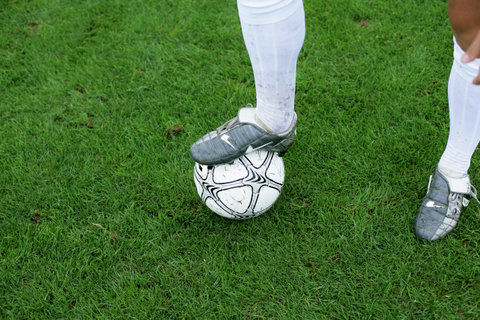 Soccer player's foot on a ball