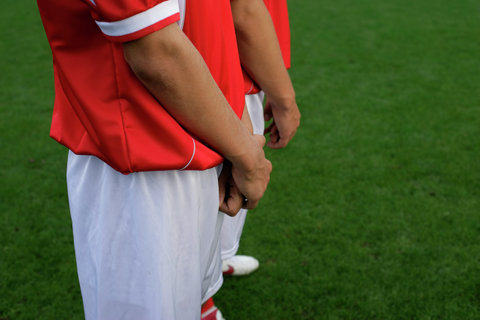 Soccer players forming a wall