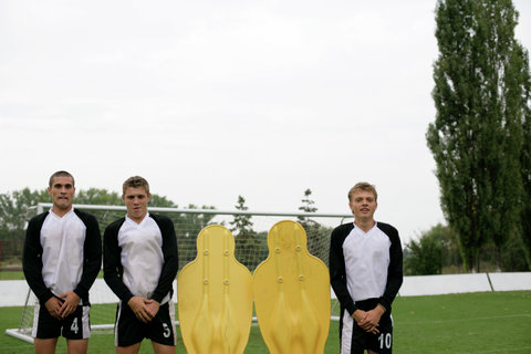 Soccer players and dummies forming a wall