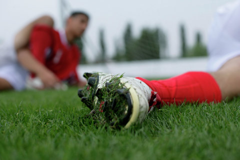 Soccer player's foot on grass