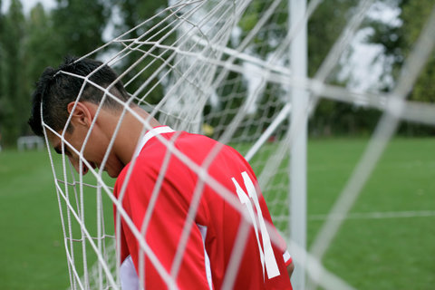 Soccer player's head in the goal net