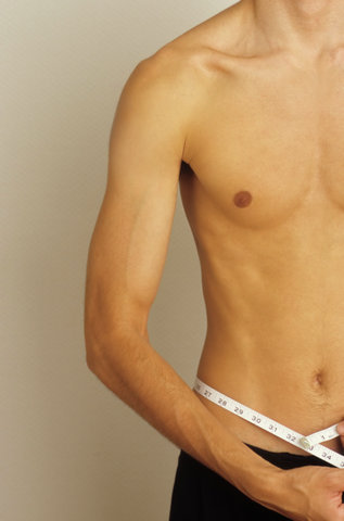 Man measuring his Waistline - Vanity - Physicalness - Exactness