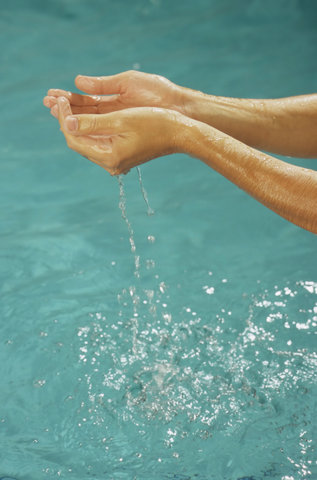 Man letting Water run through his Hands - Element - Swimming Pool - Leisure Time