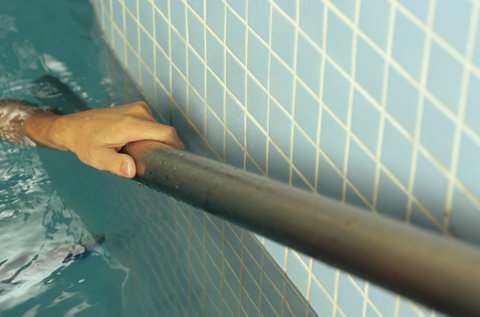Hand of a Man holding fast to a Balustrade - Baths